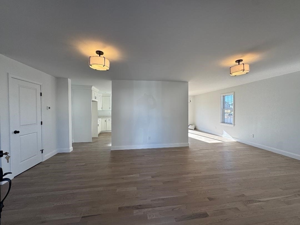 917 Dwelly Street Fall River, MA 02724 - Photo 4 of 22 a view of empty room with wooden floor and window