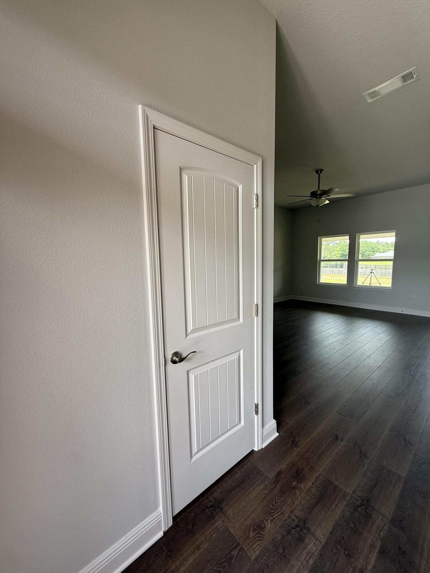 6004 Crocket Cove Crestview, FL 32539 - Photo 8 of 24 an empty room with wooden floor and windows