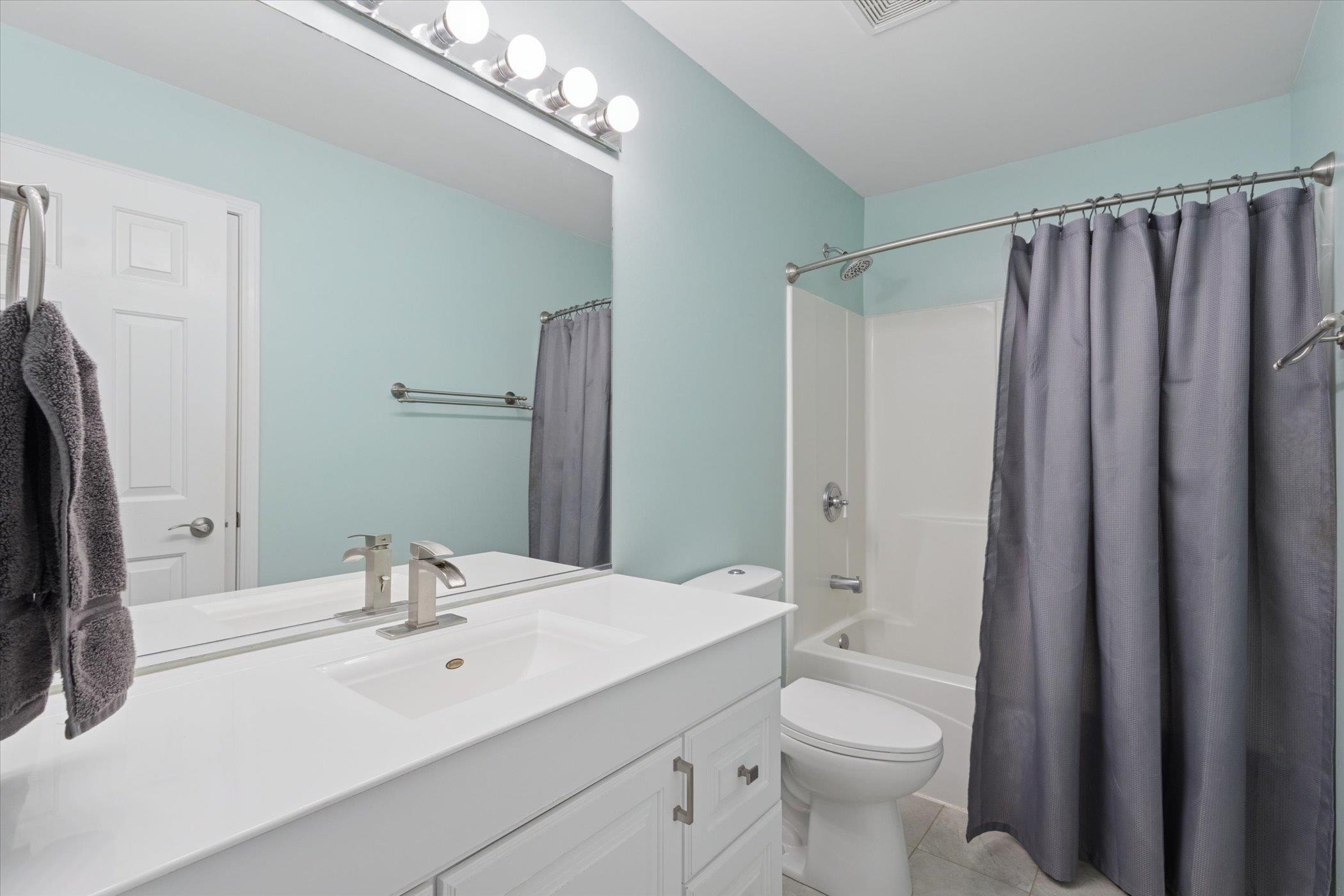 718 West Prospect Street Kirkland, IL 60146 - Photo 26 of 41 a bathroom with a double vanity sink toilet mirror and shower