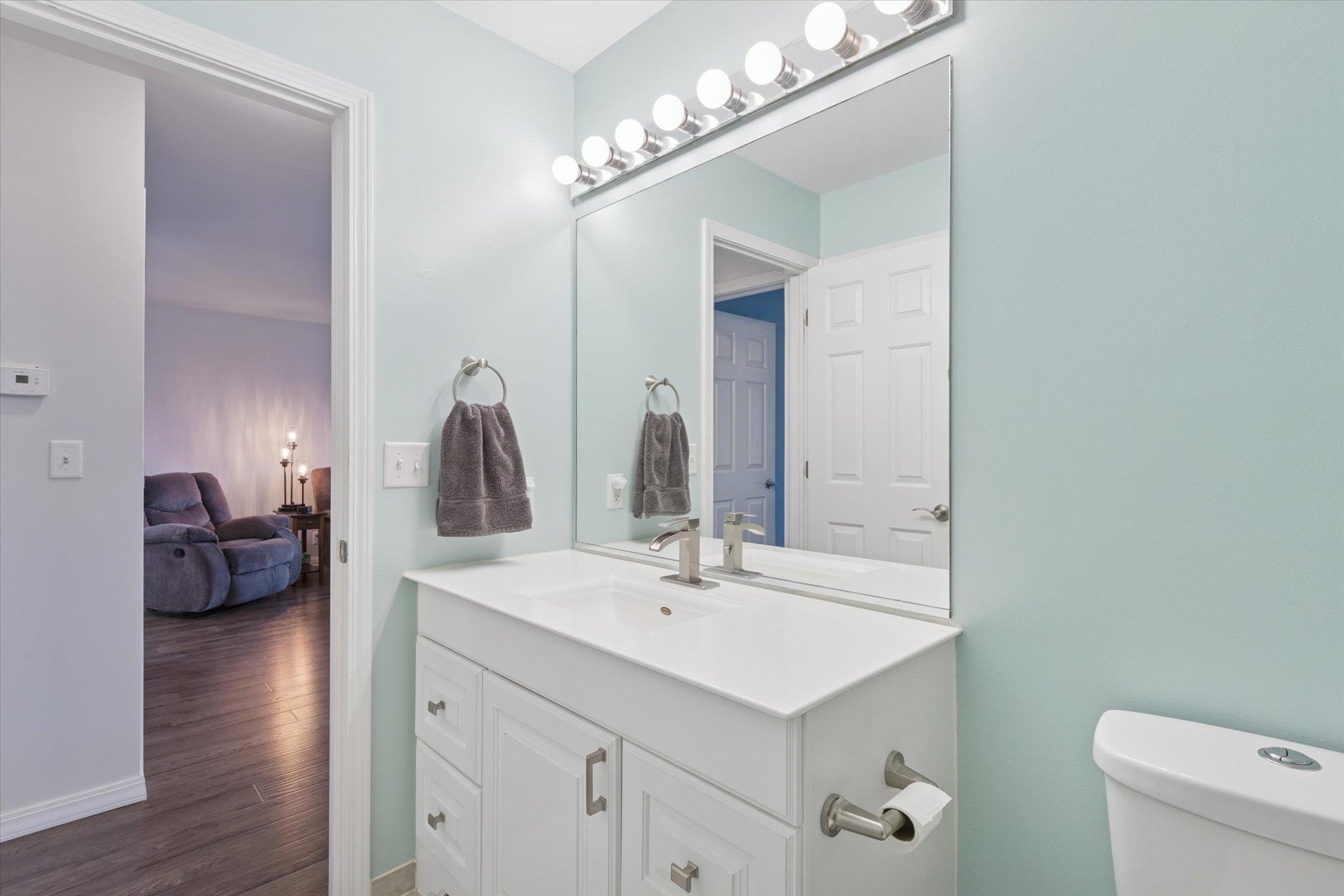 718 West Prospect Street Kirkland, IL 60146 - Photo 27 of 41 a en suite bathroom with a double vanity sink and a mirror