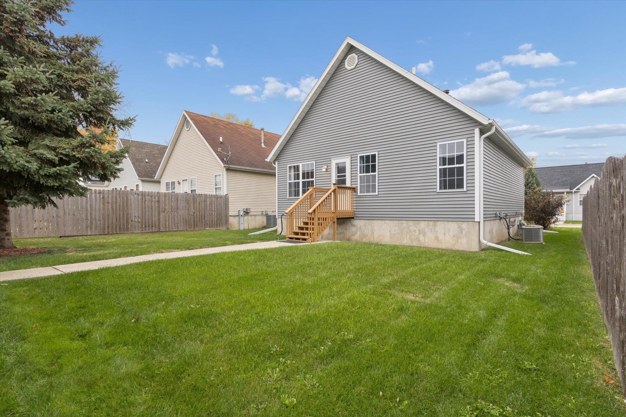 718 West Prospect Street Kirkland, IL 60146 - Photo 6 of 41 a view of a backyard with table and chairs and a barbeque