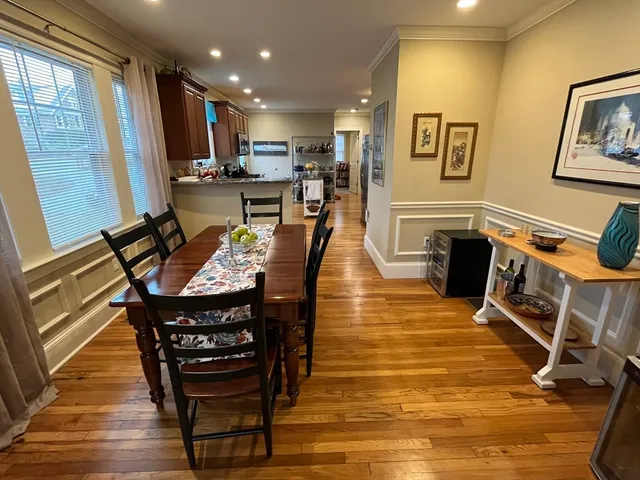 a dining room with furniture and wooden floor
