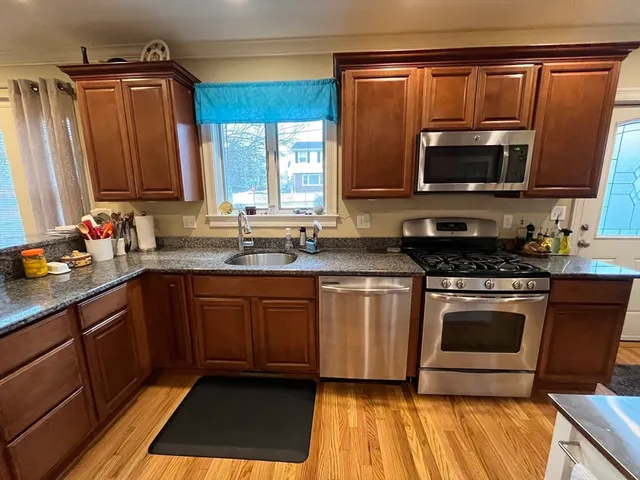 a kitchen with a sink stove and microwave