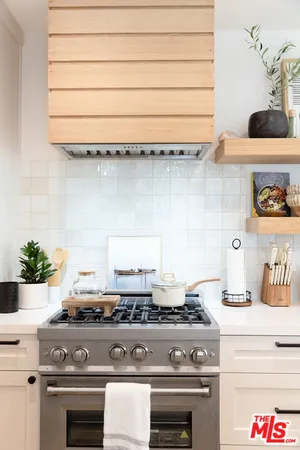 a stove top oven sitting inside of a kitchen