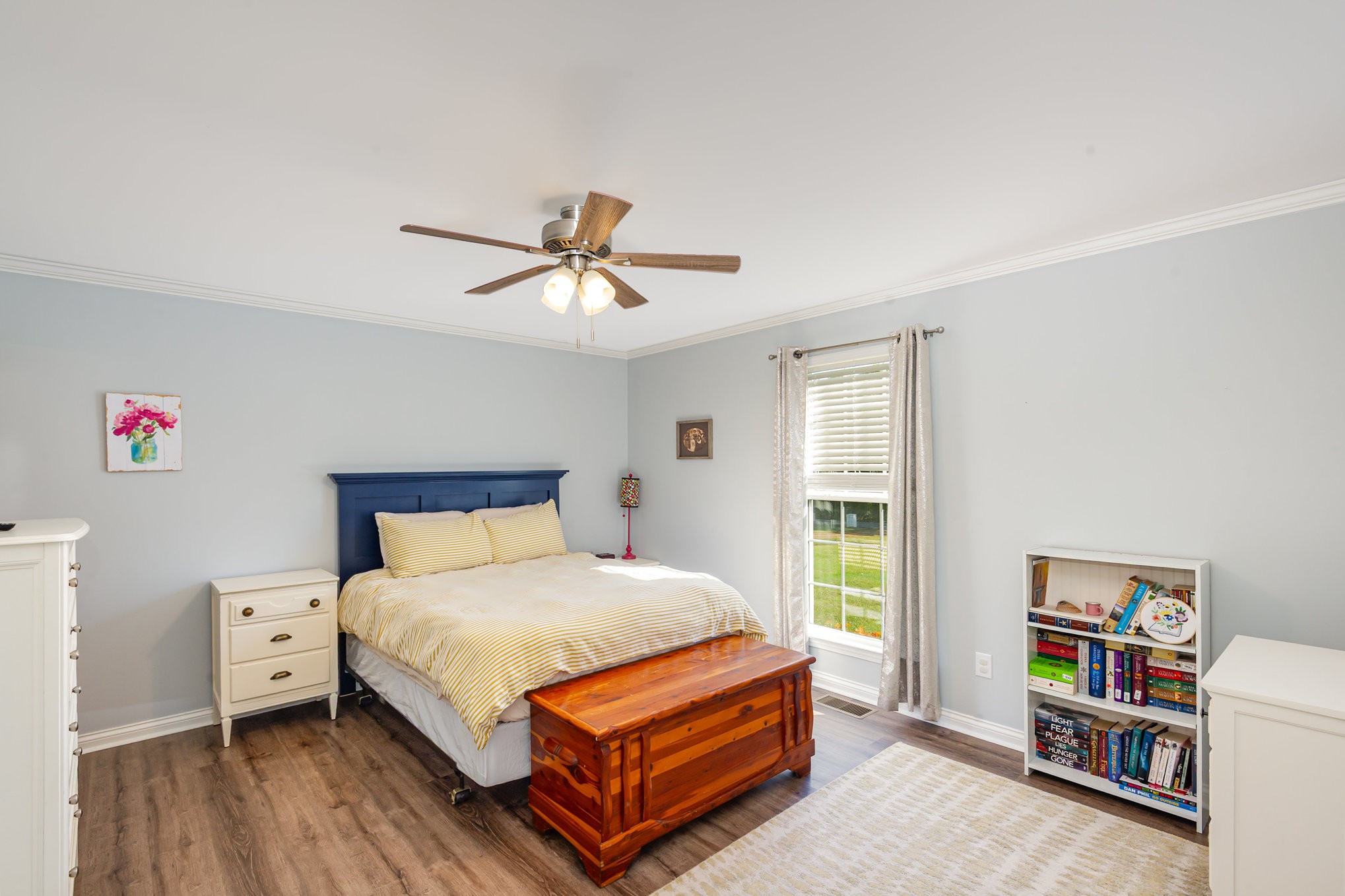 879 Rock Bridge Road Bethpage, TN 37022 - Photo 19 of 39 a bedroom with a bed a dresser and book shelf