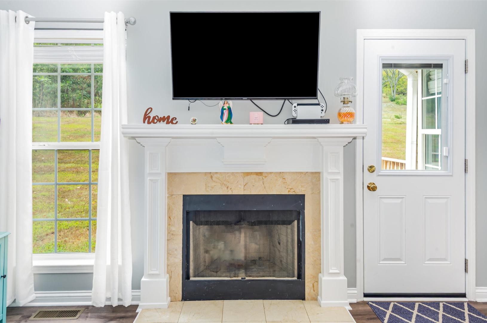 879 Rock Bridge Road Bethpage, TN 37022 - Photo 10 of 39 a living room with a fireplace and a flat screen tv