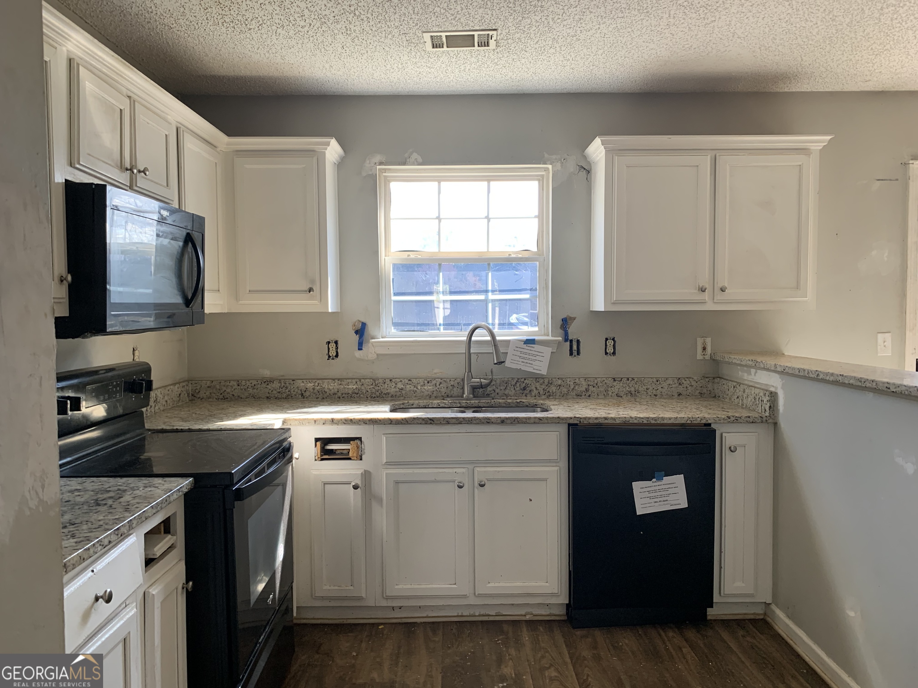 520 Vineyard Road Griffin, GA 30223 - Photo 4 of 6 a kitchen with stainless steel appliances granite countertop a sink stove and cabinets