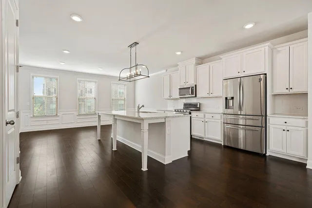 a kitchen with stainless steel appliances a refrigerator sink and microwave