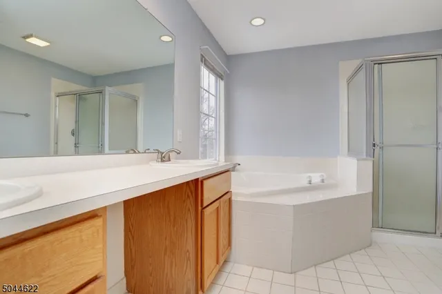 a bathroom with a sink a vanity and a bathtub