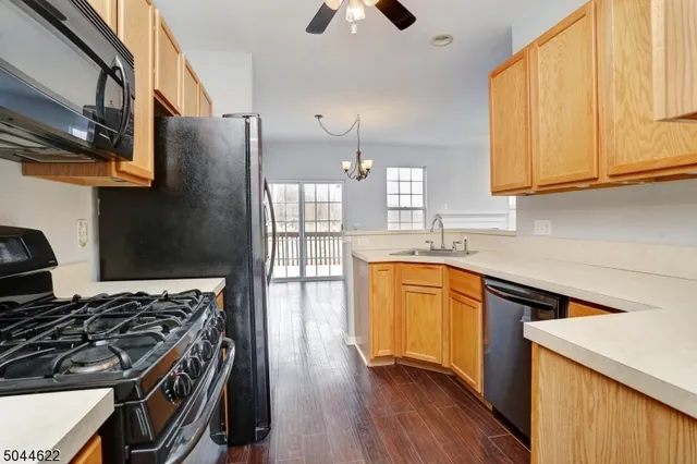 a kitchen with stainless steel appliances granite countertop a stove a sink dishwasher and a refrigerator