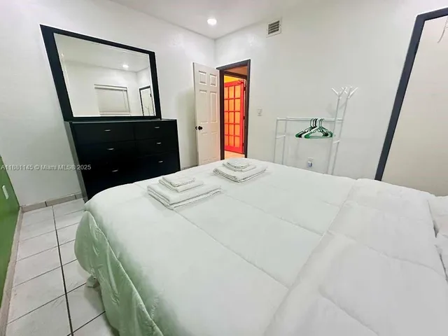 a bedroom with a bed and a lamp