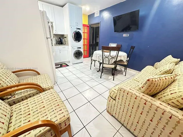 a bedroom with a bed a flat screen tv and a couch