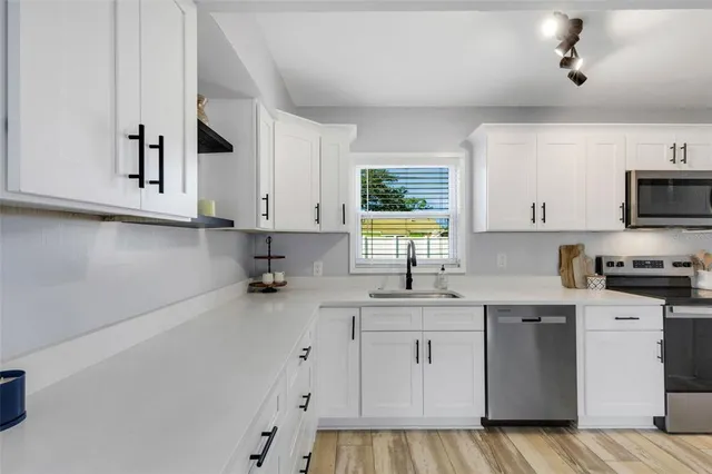 a kitchen with a sink cabinets and window