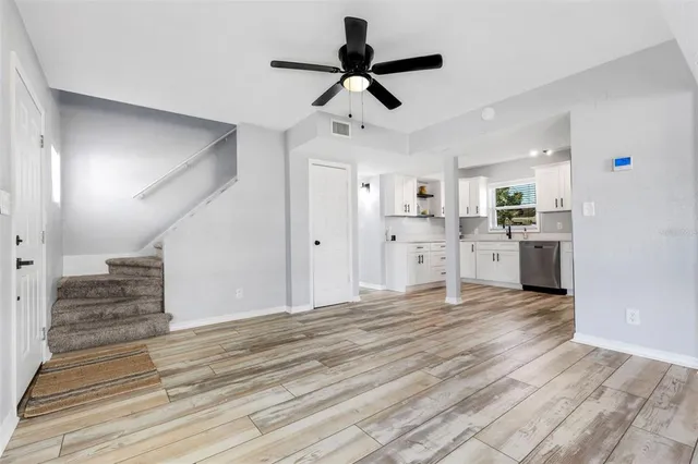 a view of a kitchen with a refrigerator and a stove top oven