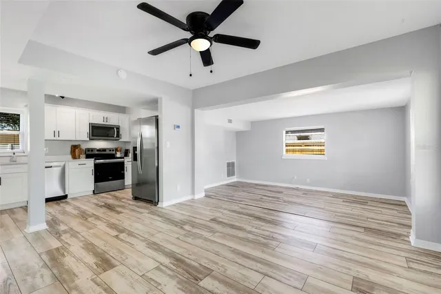 a view of kitchen with sink microwave and refrigerator
