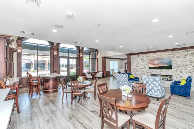 a kitchen with granite countertop a sink stove and refrigerator