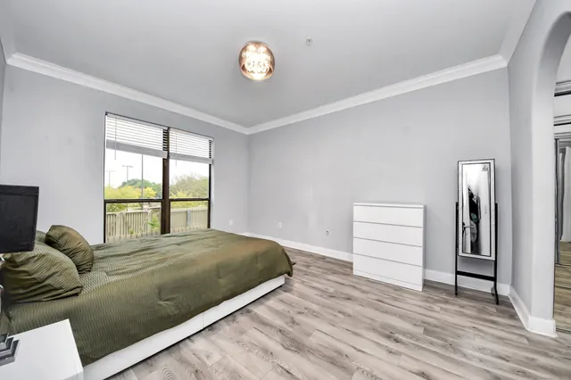 a living room with a bed furniture and a large window