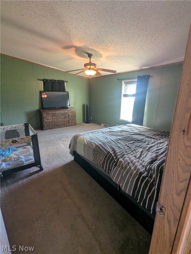 17960 Raven Road Salesville, OH 43778 - Photo 17 of 27 Room featuring a ceiling fan with integrated lighting, a window with blinds, and carpet flooring