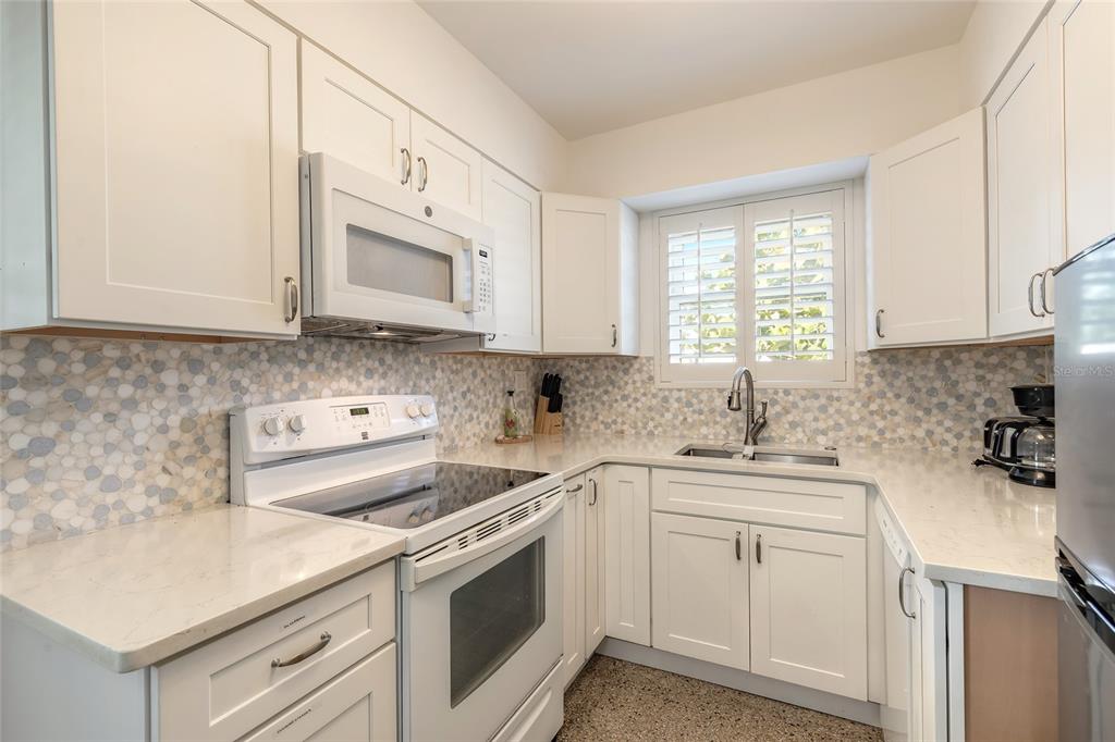 3948 Cardinal Boulevard Port Orange, FL 32127 - Photo 11 of 37 a kitchen with cabinets appliances a sink and a window