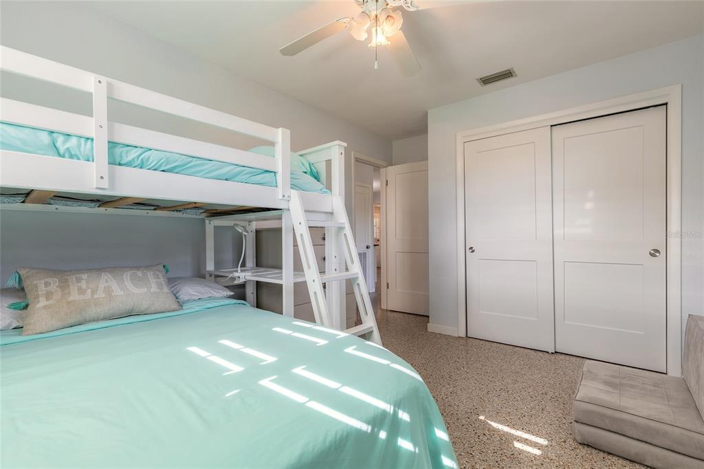 3948 Cardinal Boulevard Port Orange, FL 32127 - Photo 13 of 37 a bedroom with a bed and a flat tv screen
