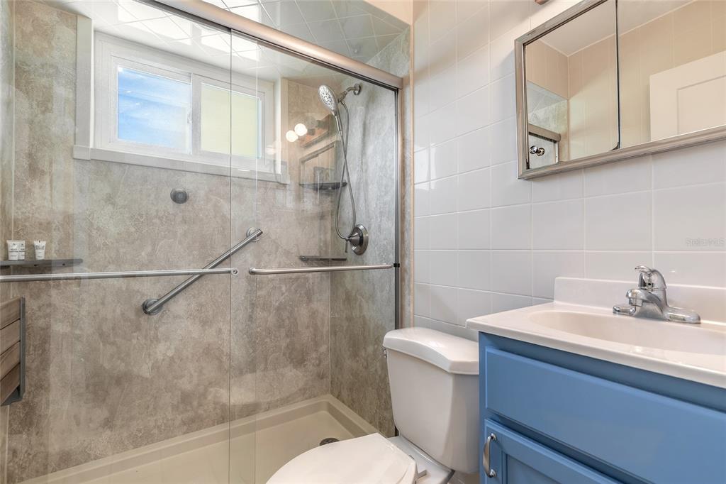 3948 Cardinal Boulevard Port Orange, FL 32127 - Photo 15 of 37 a bathroom with a sink a mirror and a toilet