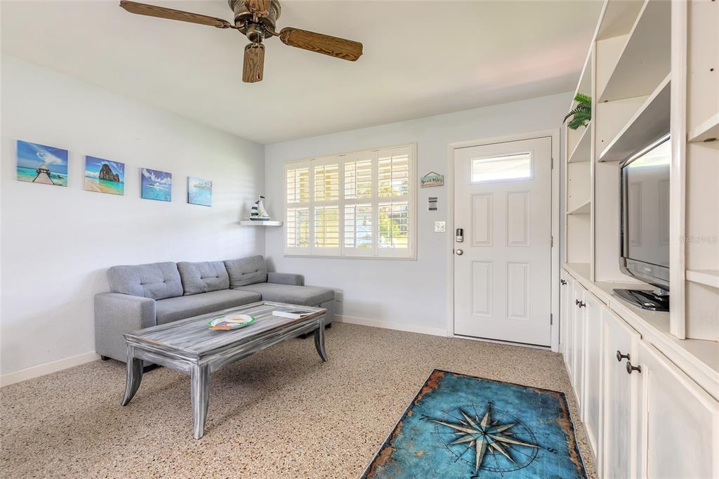 3948 Cardinal Boulevard Port Orange, FL 32127 - Photo 2 of 37 a living room with furniture a flat screen tv and a window