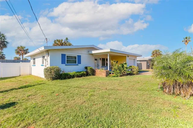 a view of a house next to a big yard