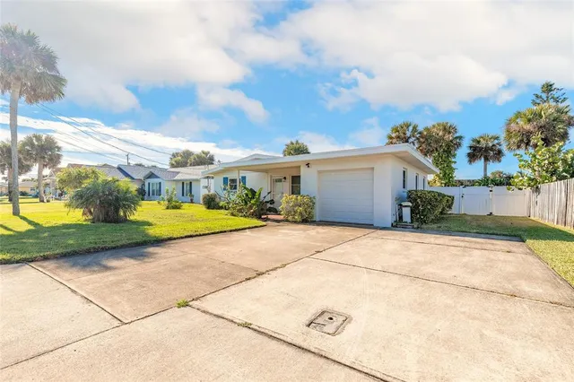 a view of backyard of house and car parked