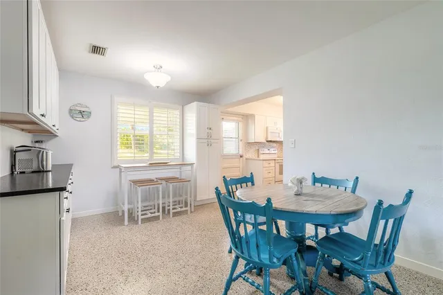 a view of a dining room with furniture and a window