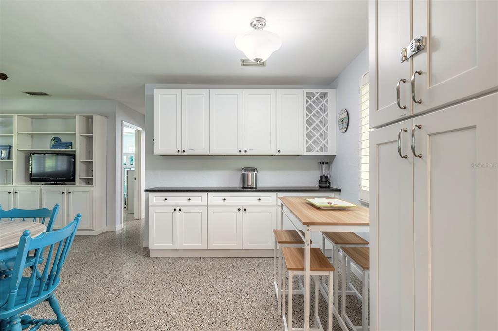 3948 Cardinal Boulevard Port Orange, FL 32127 - Photo 7 of 37 a kitchen with stainless steel appliances white cabinets and a refrigerator