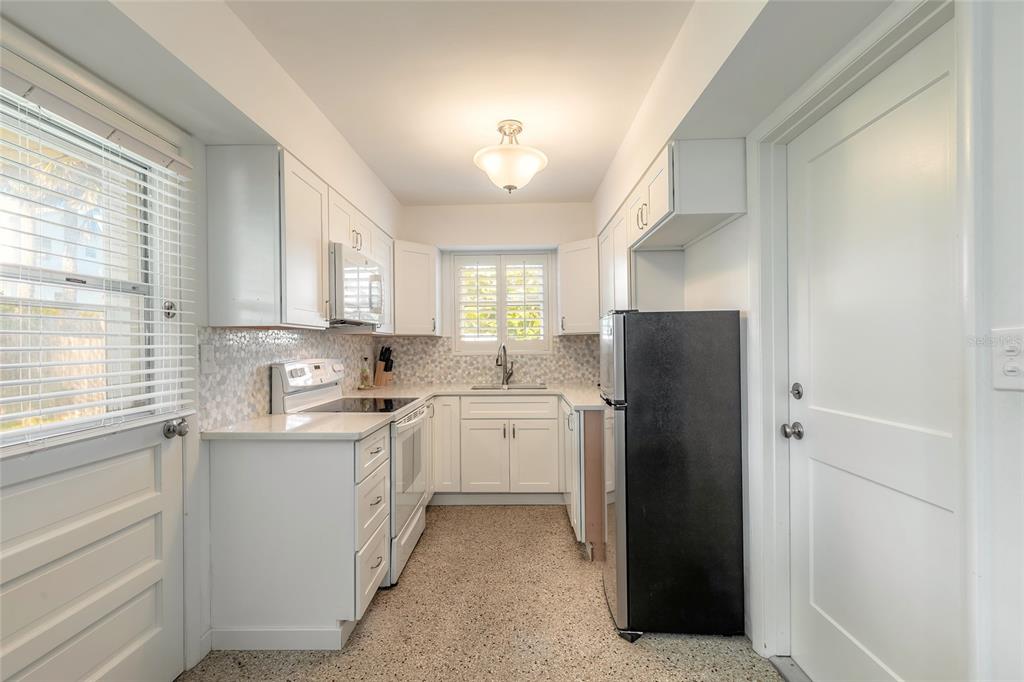 3948 Cardinal Boulevard Port Orange, FL 32127 - Photo 10 of 37 a kitchen with a refrigerator sink and cabinets