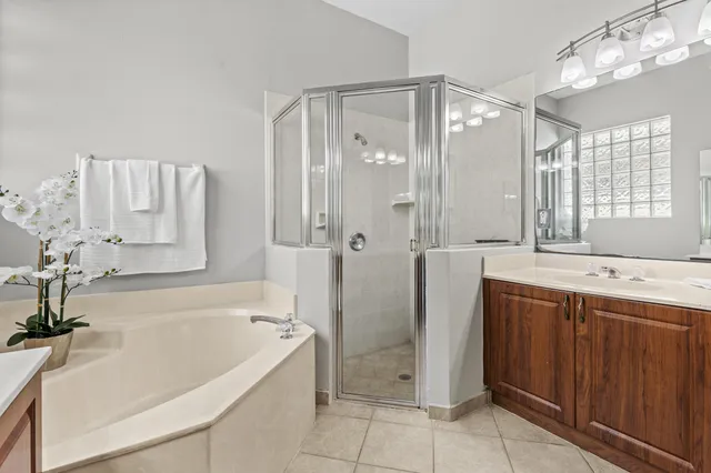 a bathroom with a double vanity sink toilet and a mirror