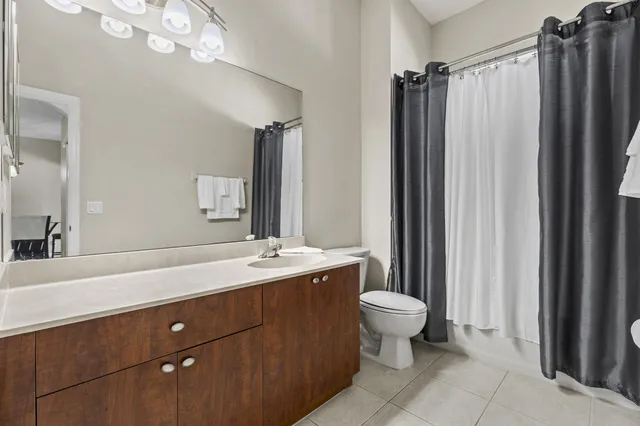 a bathroom with a sink mirror vanity and toilet