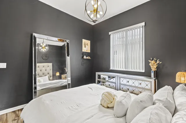 an aerial view of residential houses with outdoor space and trees