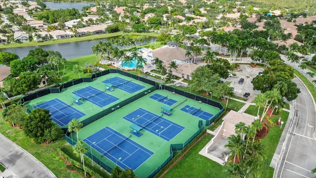 an aerial view of a tennis ground and a lake view