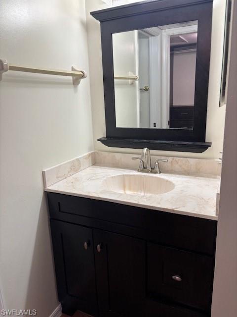 1220 Commonwealth Circle, Unit M206 Naples, FL 34116 - Photo 5 of 8 a bathroom with a sink vanity and a mirror