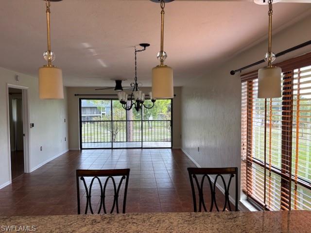 1220 Commonwealth Circle, Unit M206 Naples, FL 34116 - Photo 6 of 8 a view of a dining room with furniture window and wooden floor