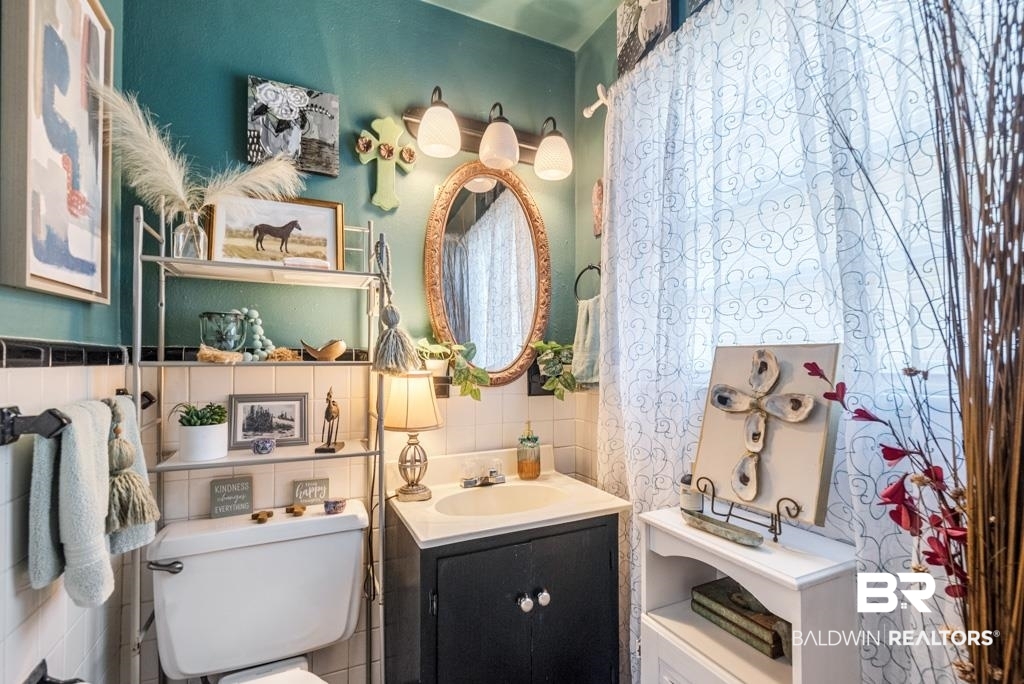 109 Esplanade Avenue Mobile, AL 36606 - Photo 15 of 45 Bathroom with vanity and tile walls