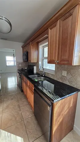a kitchen with stainless steel appliances granite countertop a sink stove and cabinets