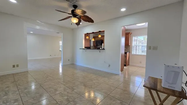 a view of an empty room with a fan