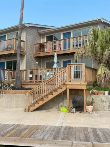 a view of a house with wooden deck