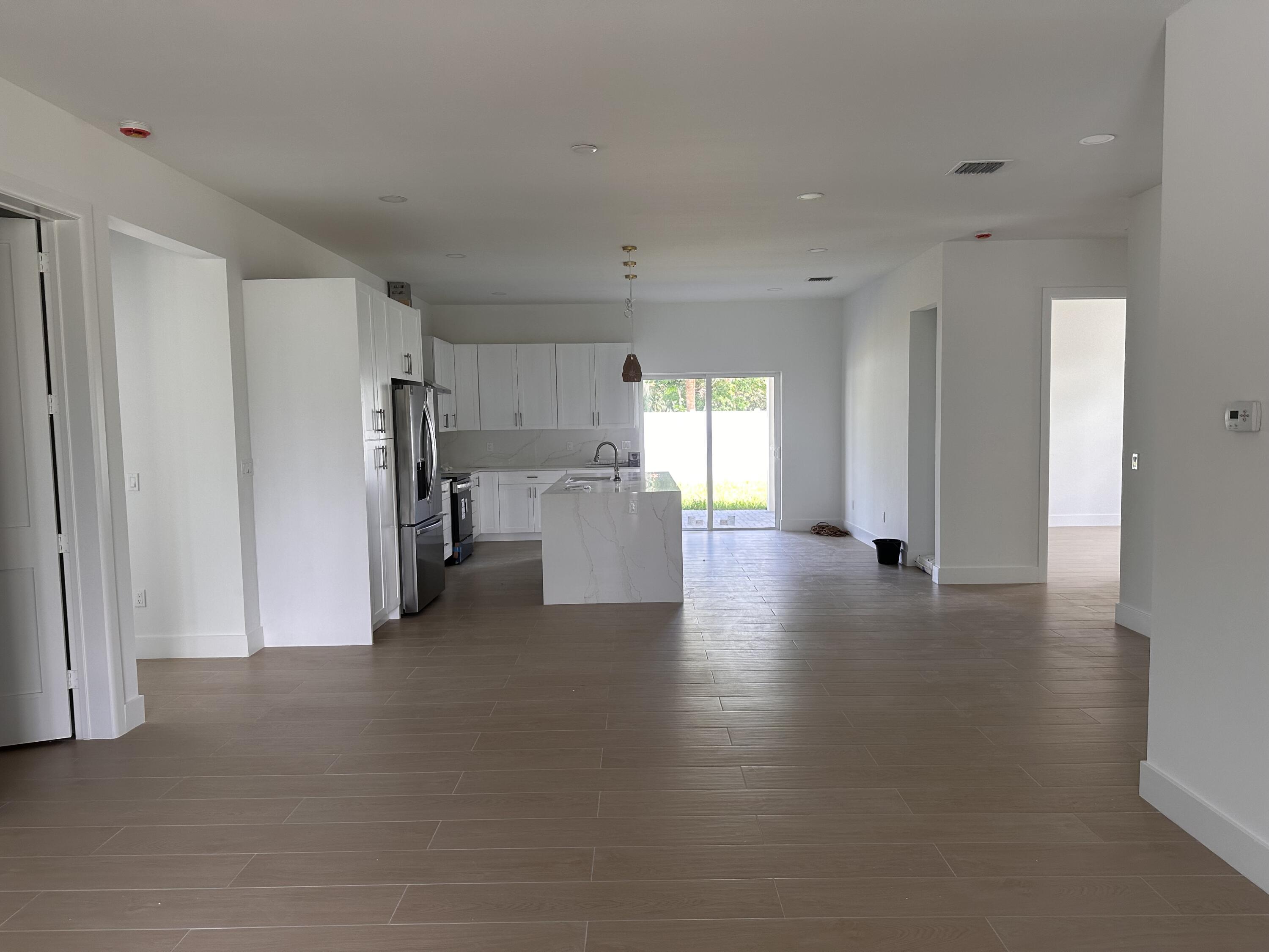 106 Northview Drive Jupiter, FL 33458 - Photo 11 of 13 a view of a kitchen with a refrigerator a sink and a refrigerator
