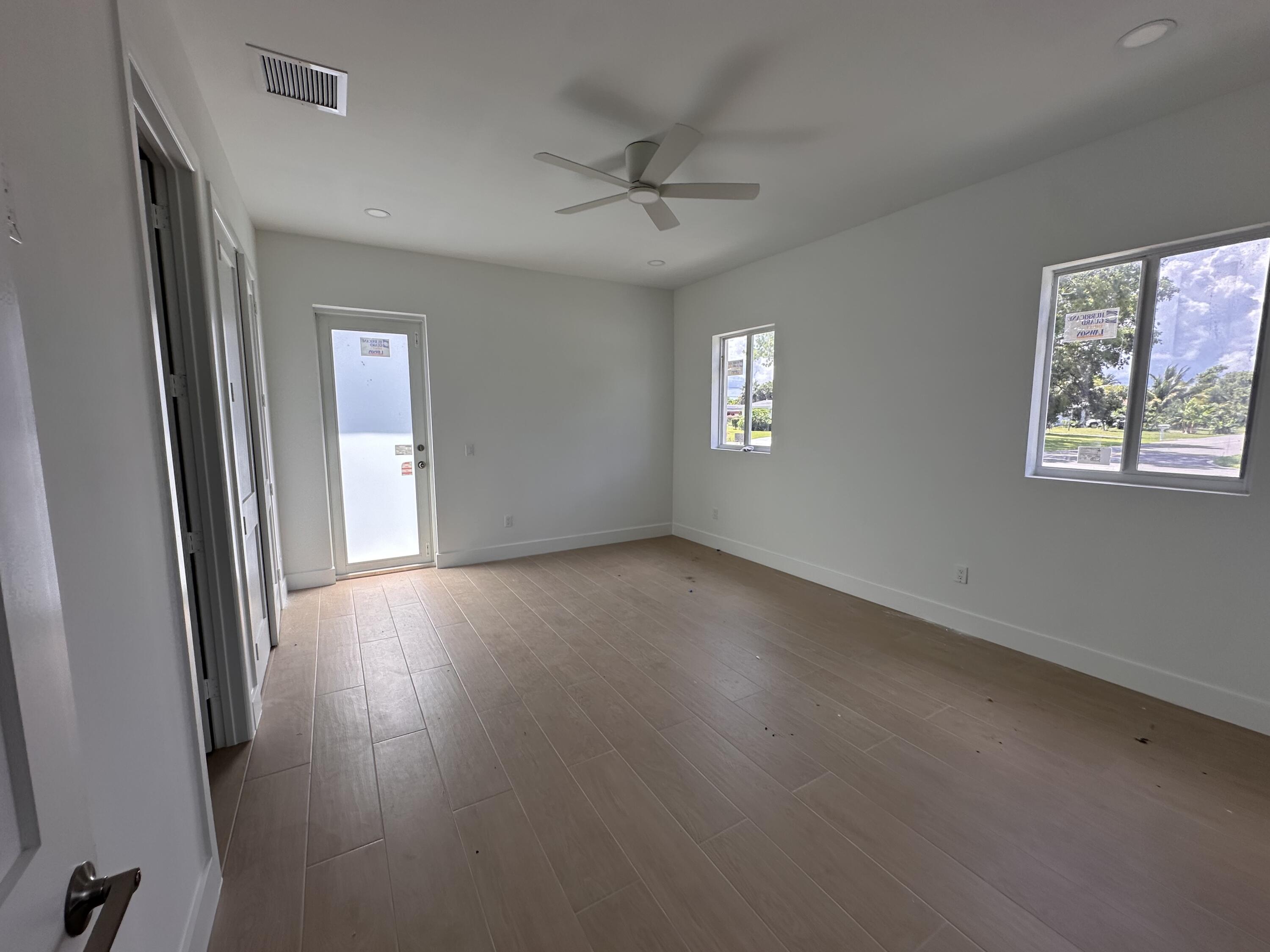 106 Northview Drive Jupiter, FL 33458 - Photo 12 of 13 a view of a livingroom with wooden floor and a window