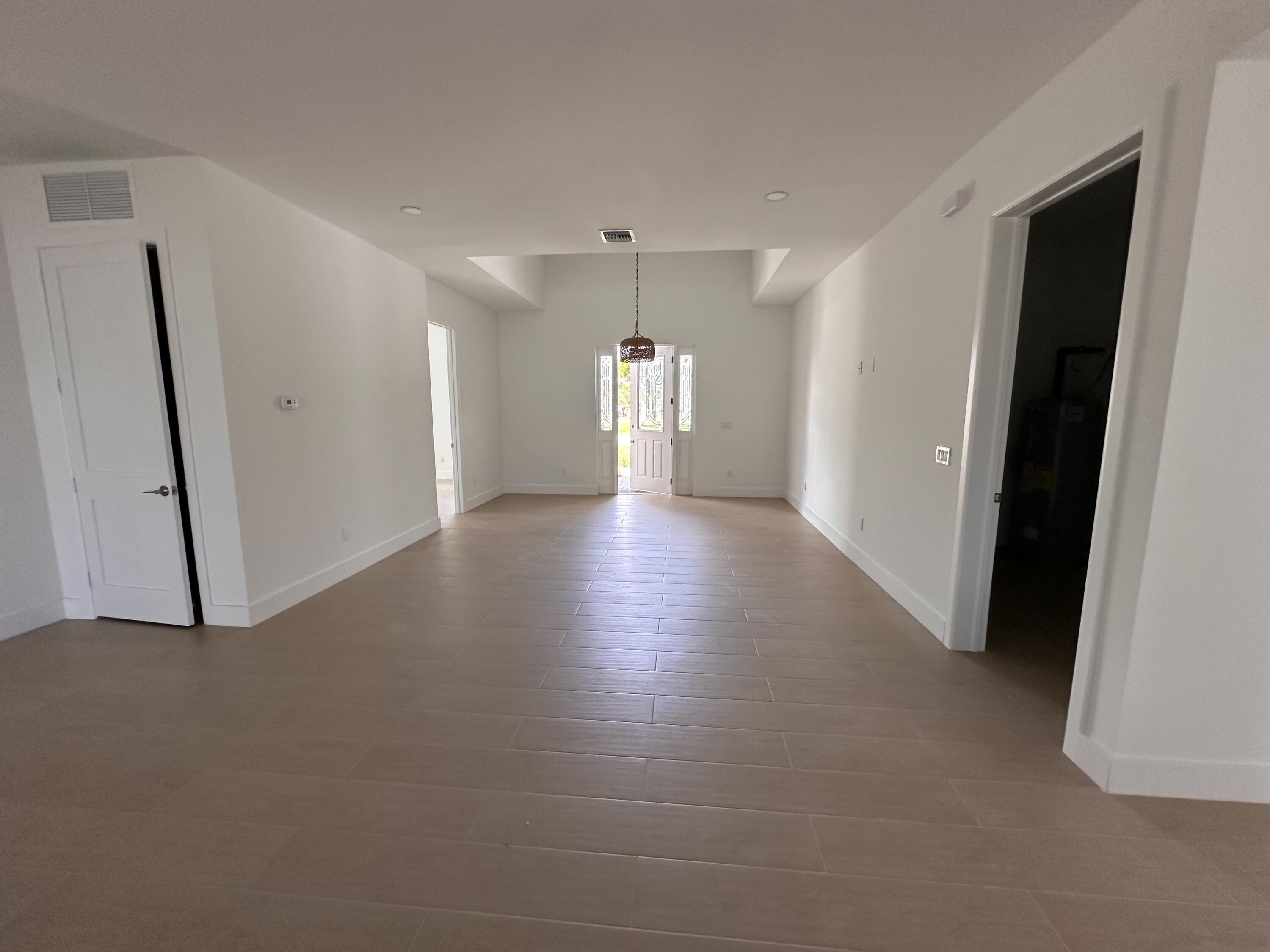 106 Northview Drive Jupiter, FL 33458 - Photo 7 of 13 a view of a livingroom with wooden floor and a window