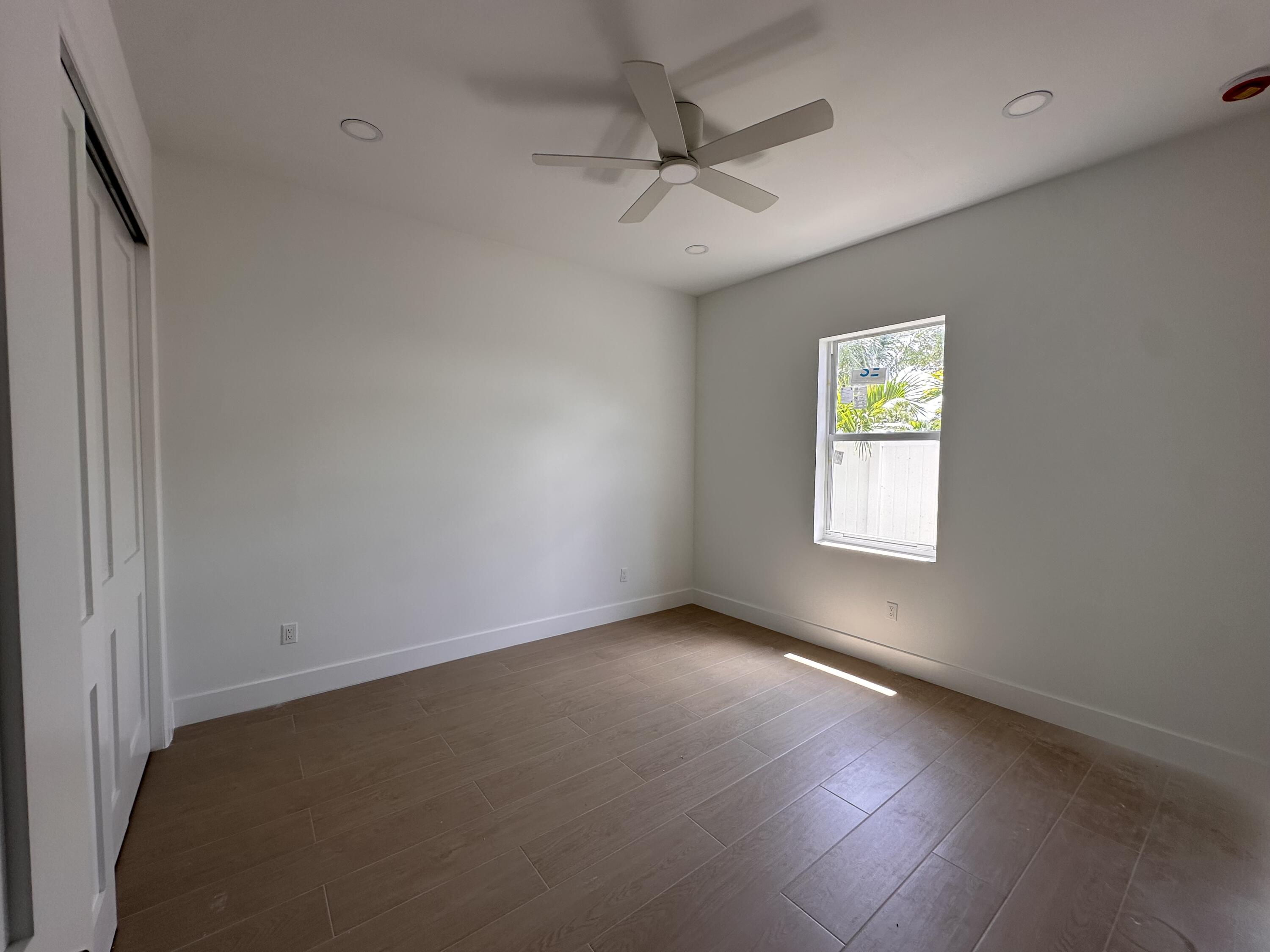 106 Northview Drive Jupiter, FL 33458 - Photo 8 of 13 an empty room with a window and a ceiling fan