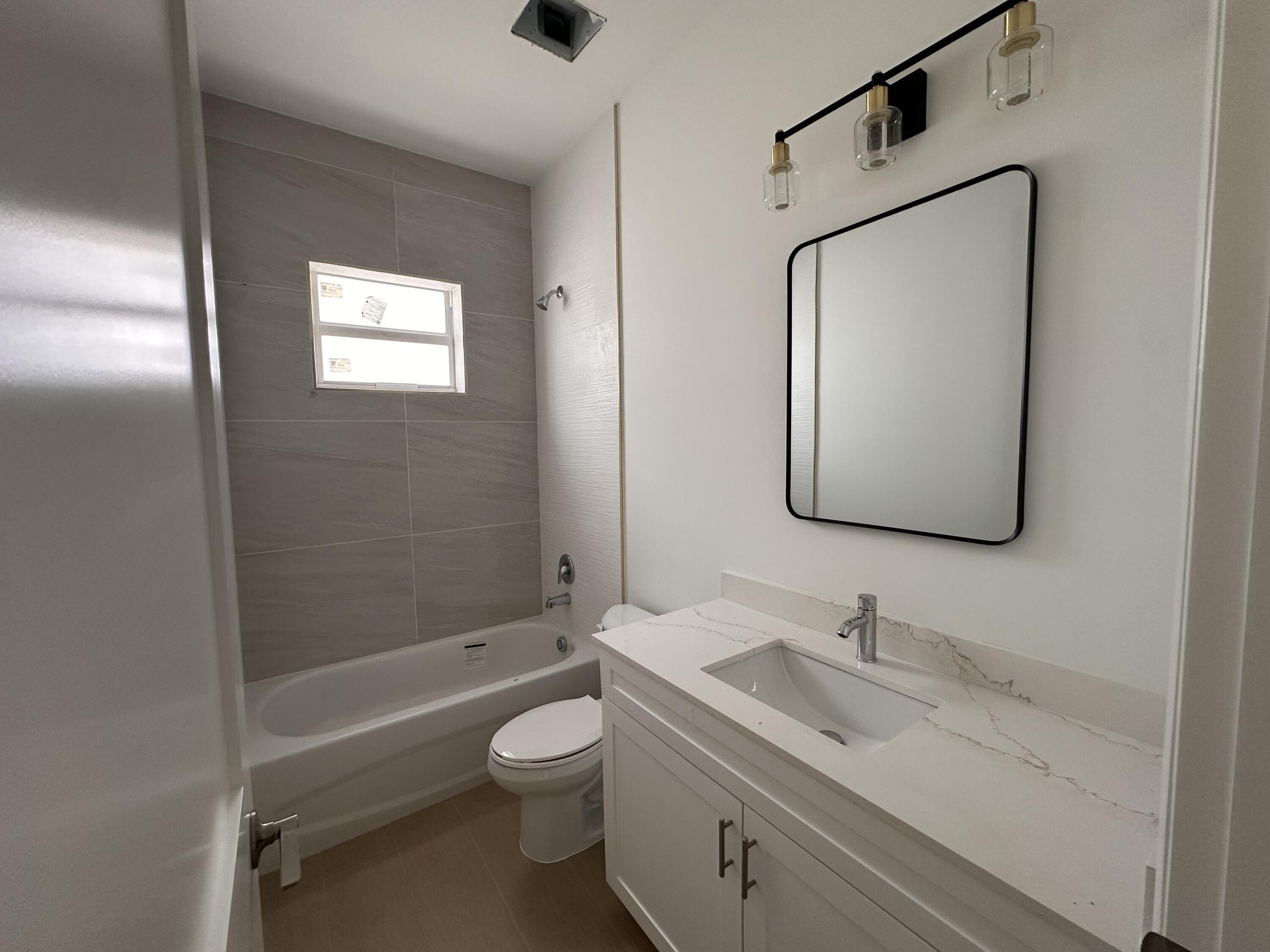 106 Northview Drive Jupiter, FL 33458 - Photo 9 of 13 a bathroom with a toilet sink vanity granite tub and shower