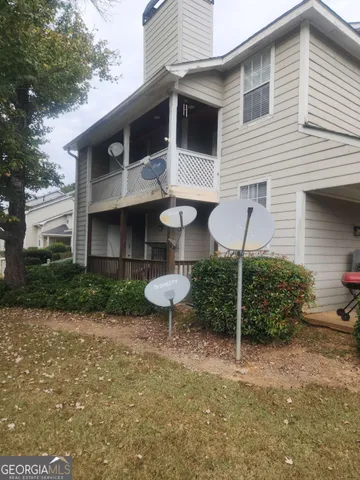 a view of a backyard with plants and a patio