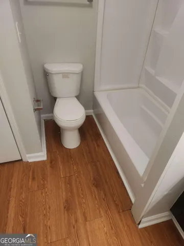 a bathroom with a toilet and a bathtub