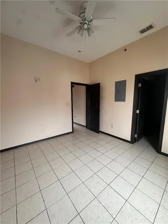 a view of a livingroom with an empty space and a ceiling fan