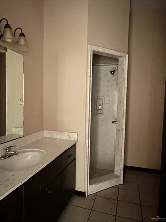 a bathroom with a granite countertop sink and a mirror